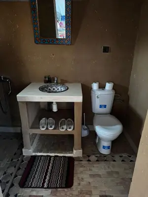a bathroom with a toilet and a sink at Luxury Desert Camp Erg Chegaga in El Gouera