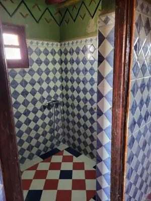 a bathroom with a shower with blue and white tiles at Luxury Desert Camp Erg Chegaga in El Gouera