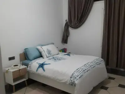 a bedroom with a bed with a starfish on it at grand apt climatisé et ensoleillé au centre de Fès in Fès