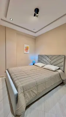 a bedroom with a large bed in a room at Joli appartement in Fès