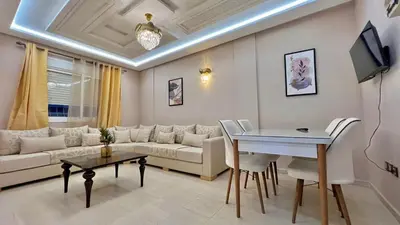 a living room with a couch and a table at Joli appartement in Fès