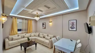 a living room with a couch and a table at Joli appartement in Fès