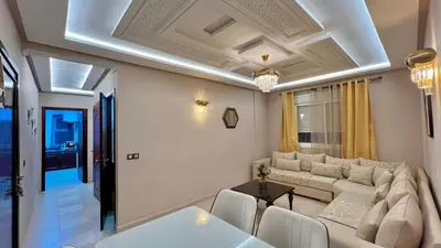 a living room with a couch and a table at Joli appartement in Fès