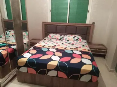 a bedroom with a bed with a colorful comforter at Top 4 Rooms Apartment in Beni Mellal