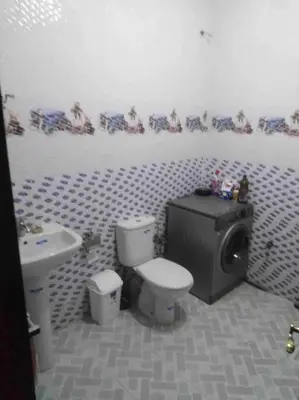 a bathroom with a toilet and a tv in it at Top 4 Rooms Apartment in Beni Mellal