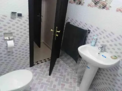 a bathroom with a toilet and a sink at Top 4 Rooms Apartment in Beni Mellal