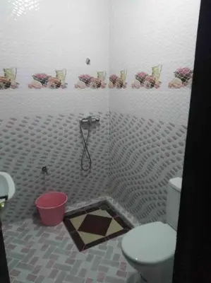 a bathroom with a toilet and a shower in it at Top 4 Rooms Apartment in Beni Mellal