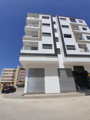 a tall building with a car parked in front of it at Apartment Oued Fes close to Euromed in Fès
