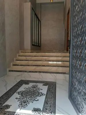 a hallway with a rug on the floor and stairs at Apartment Oued Fes close to Euromed in Fès