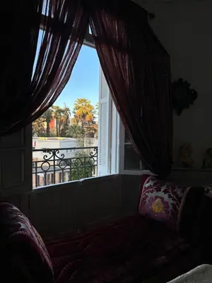 a room with a window with a view of a balcony at Chez Mia in Fès