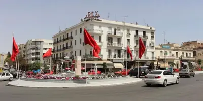 a building with red flags in the middle of a street at Chez Mia in Fès