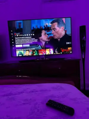 a tv in a purple room with a remote control at Chez Mia in Fès