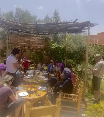 a group of people sitting around a table at kasbah De Alami hdida commune de ait ouassif kelaa mgouna tinghir in Kalaat MGouna