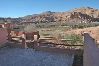 a view of a desert with a fence and mountains at kasbah De Alami hdida commune de ait ouassif kelaa mgouna tinghir in Kalaat MGouna