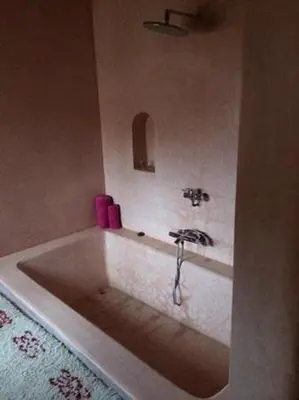 a bathroom with a bath tub with a sink at kasbah De Alami hdida commune de ait ouassif kelaa mgouna tinghir in Kalaat MGouna