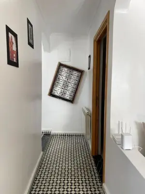 a hallway with a black and white tiled floor at Appartement Fatima in Azrou
