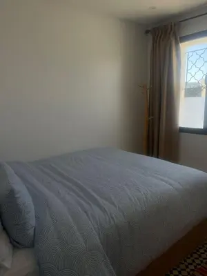 a bedroom with a bed and a window at Appartement Fatima in Azrou