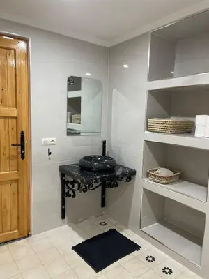 a bathroom with a black sink and a mirror at Appartement Fatima in Azrou
