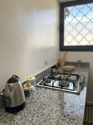 a kitchen counter with a stove and a window at Appartement Fatima in Azrou