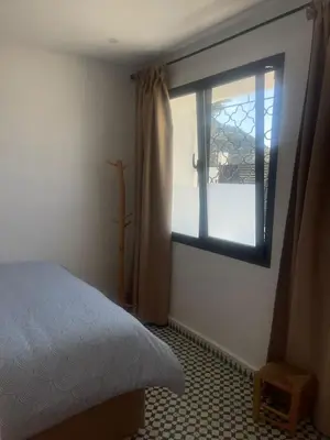 a bedroom with a bed and a window at Appartement Fatima in Azrou