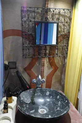 a sink in a bathroom with a mirror and a phone at Morocco Stars Camp in Hassilabied