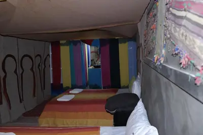 a room with two beds and a colorful wall at Morocco Stars Camp in Hassilabied