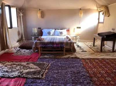 a bedroom with a bed in a tent at Morocco Stars Camp in Hassilabied