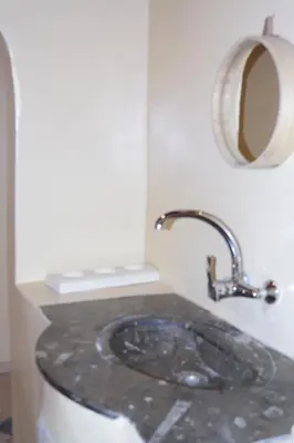 a bathroom with a sink and a mirror on a counter at Morocco Stars Camp in Hassilabied
