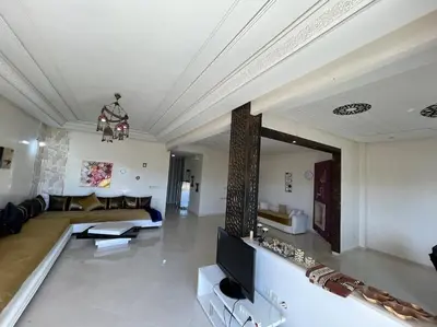 a living room with a couch and a tv at Appartement spacieux in Fès