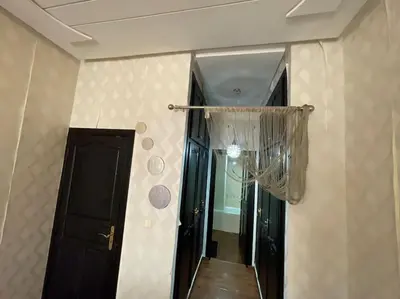 a hallway with a door and a mirror in a room at Appartement spacieux in Fès
