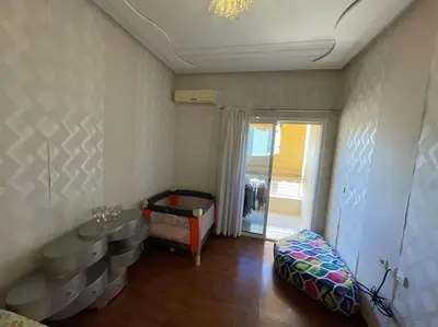 a room with a bedroom with a bed and a window at Appartement spacieux in Fès
