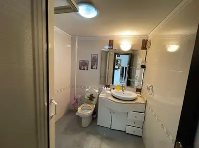 a bathroom with a sink and a toilet and a mirror at Appartement spacieux in Fès