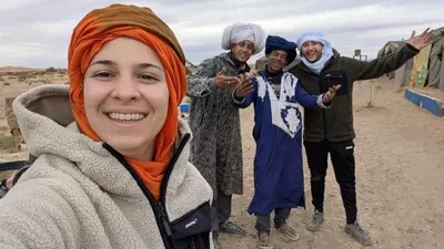 a group of people posing for a picture at Sahara binich sercices in Merzouga