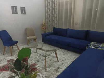 a living room with a blue couch and chairs at Golden Mirage in Fès