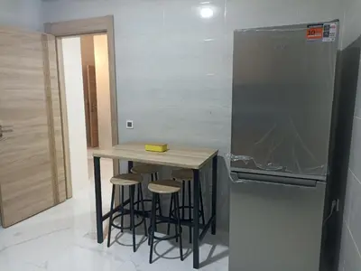 a small kitchen with a counter and a refrigerator at Golden Mirage in Fès