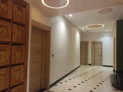 an empty hallway with a door and a tile floor at Golden Mirage in Fès