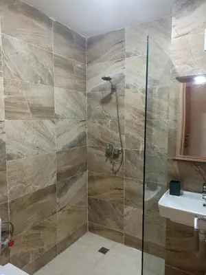 a bathroom with a shower and a sink at Golden Mirage in Fès