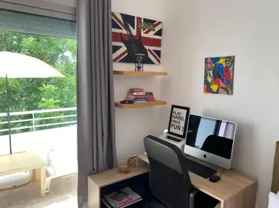 a desk with a computer monitor and a keyboard at Villa Joudia Royal Golf Fes in Fès