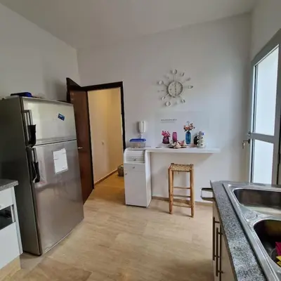 a kitchen with a refrigerator and a counter top at Villa Joudia Royal Golf Fes in Fès