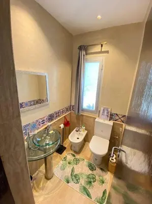 a bathroom with a toilet and a sink at Villa Joudia Royal Golf Fes in Fès