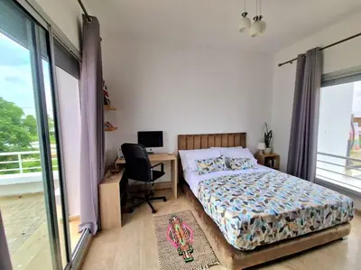 a bedroom with a bed and a desk with a computer at Villa Joudia Royal Golf Fes in Fès
