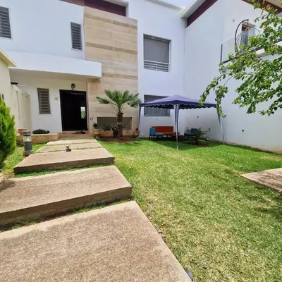a yard with steps leading to a white building at Villa Joudia Royal Golf Fes in Fès