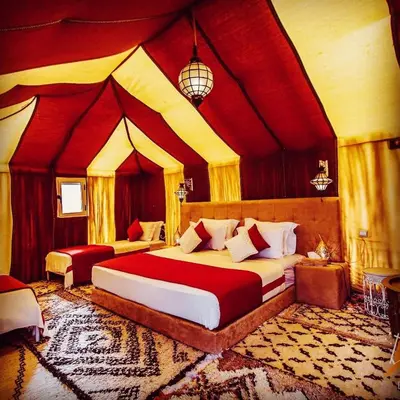 a bedroom with a large bed in a room at Camp Luxueux en plein désert de Merzouga in Merzouga