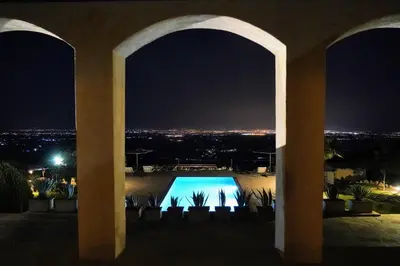 a view of a swimming pool at night at Dar El Mandar - Ferme & Table d'Hôte Berbère in Bhalil