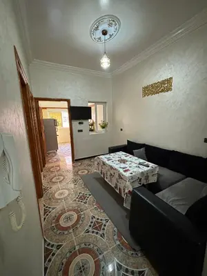 a living room with a couch and a table at Résidence MARHABA in Ouarzazate