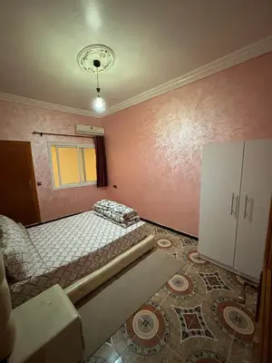 an empty room with a bed and a window at Résidence MARHABA in Ouarzazate