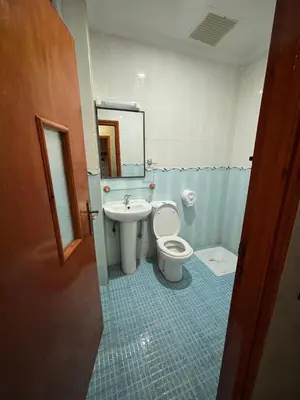 a bathroom with a toilet and a sink at Résidence MARHABA in Ouarzazate