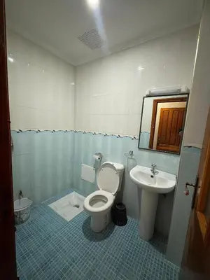 a bathroom with a toilet and a sink at Résidence MARHABA in Ouarzazate