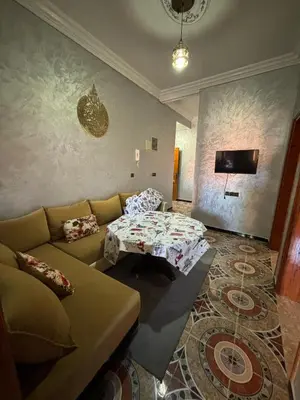 a living room with a couch and a table at Résidence MARHABA in Ouarzazate