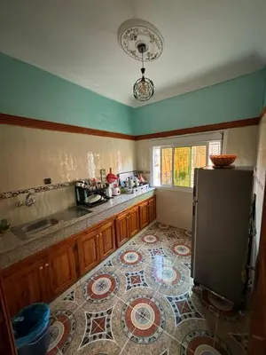 a kitchen with a sink and a refrigerator at Résidence MARHABA in Ouarzazate